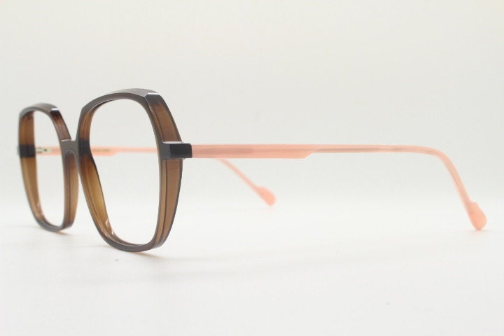 Caroline Abram square hexagon eye glasses model Caline. Dark brown acetate optical frame with pink arms. Prescription RX spectacles