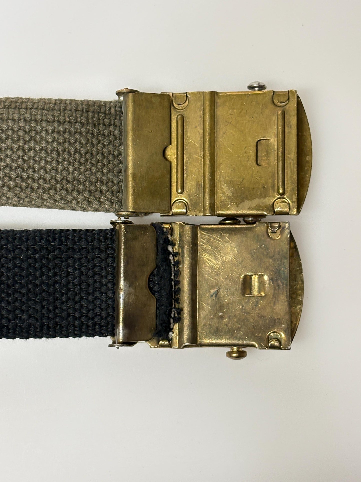 2 x bundle 80s vintage canvas army belts. One black plus one khaki green no holes format. Slide lock gold buckle. Webbing. Fully adjustable