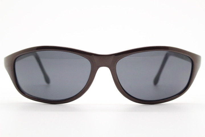 Y2K vintage wrap around shield sunglasses. Brown aerodynamic high gloss frame with black curved lenses. 2000's sport. New Old Stock 90s