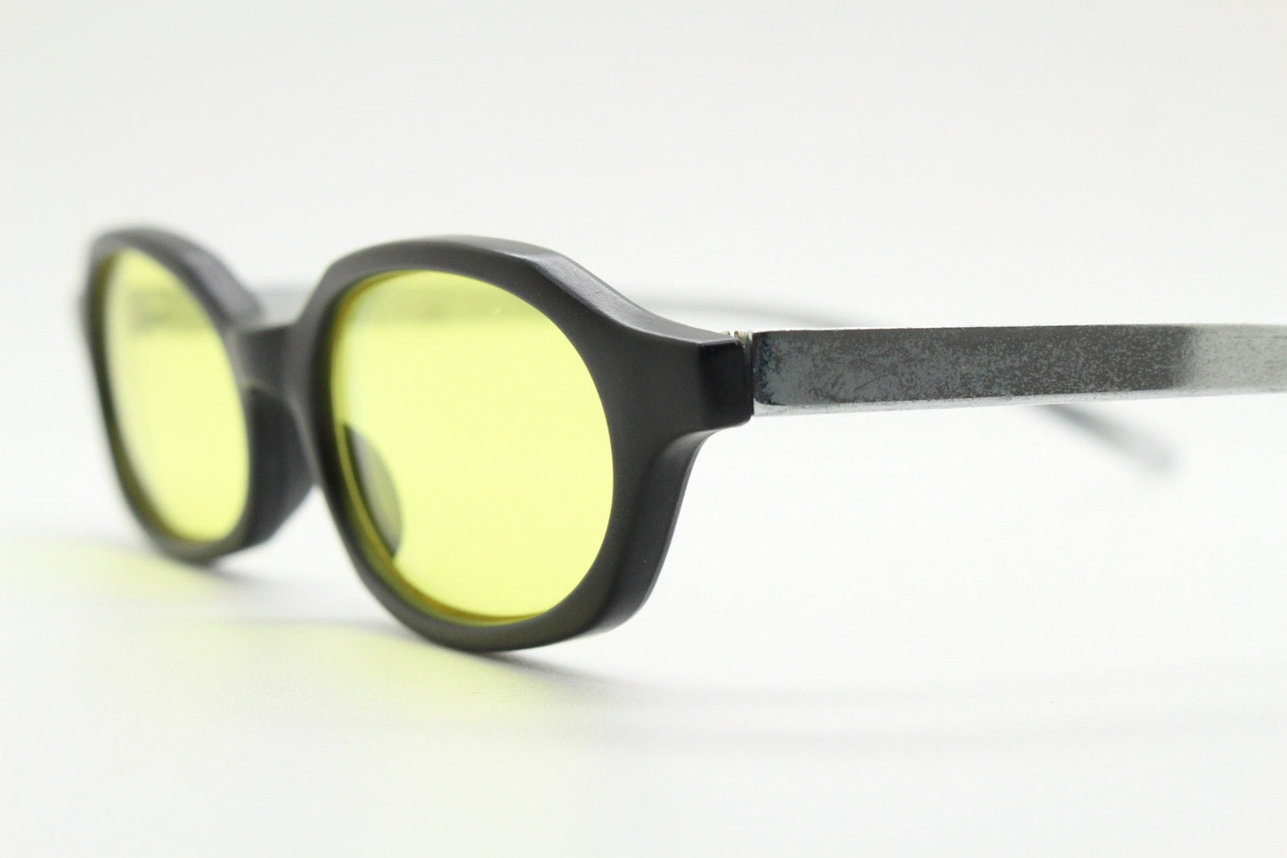 Vintage 90s oval sunglasses. Black low profile matt finish front with yellow lenses and silver chrome arms. Micro