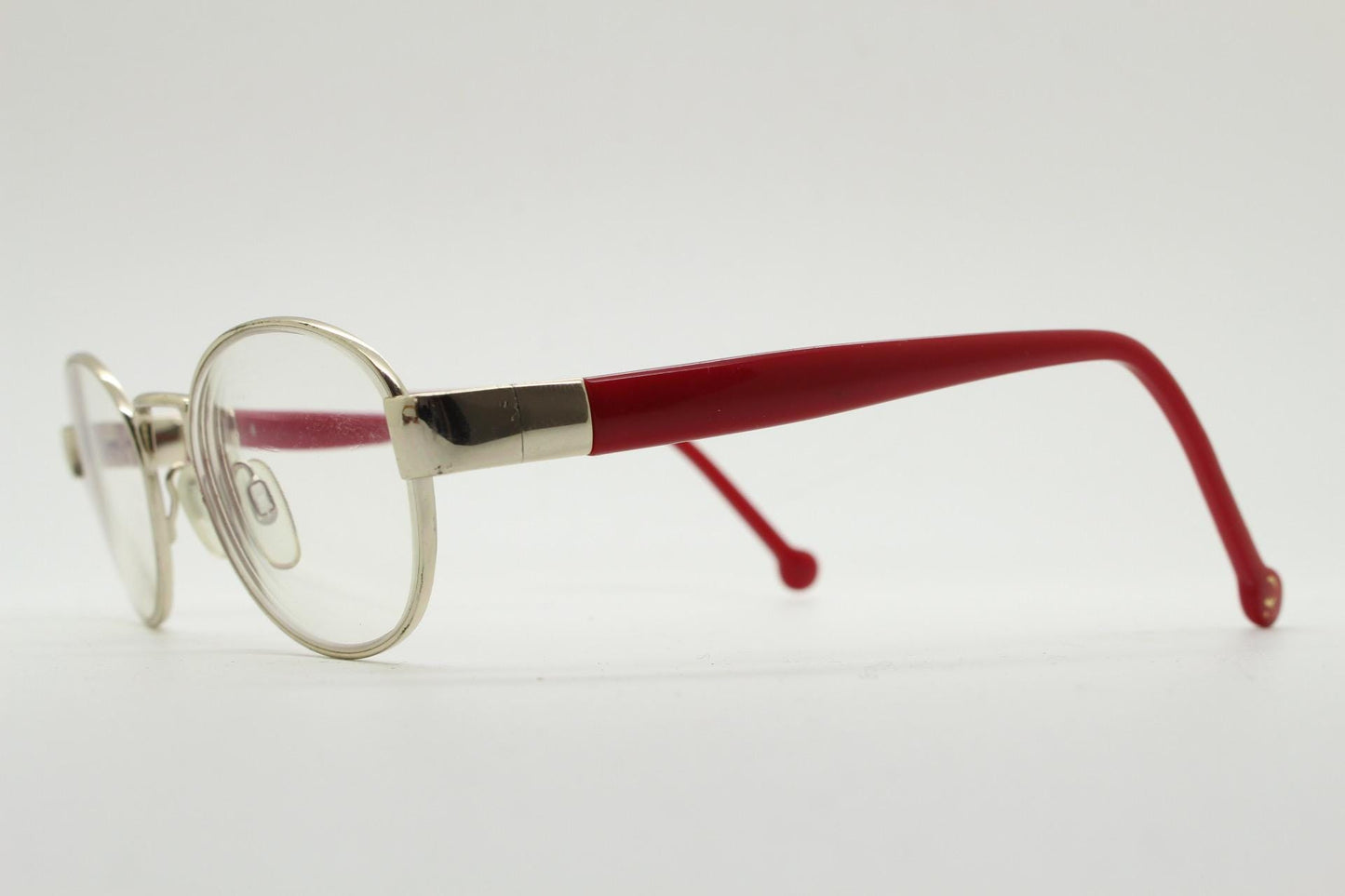 Red or Dead Y2K vintage oval eye glasses. Green or red interchangeable arms on a chrome metal frame. Optical prescription eyeglasses. RX