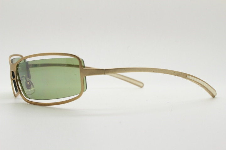 Y2K vintage wraparound sunglasses. Low profile satin finish golden slender frame with green lenses and gap feature. 2000's. 90s. NOS