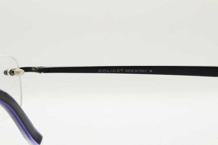 Police 90s vintage rectangular frameless eye glasses made in Italy. Minimal low profile optical frame with black satin metal trim. RX