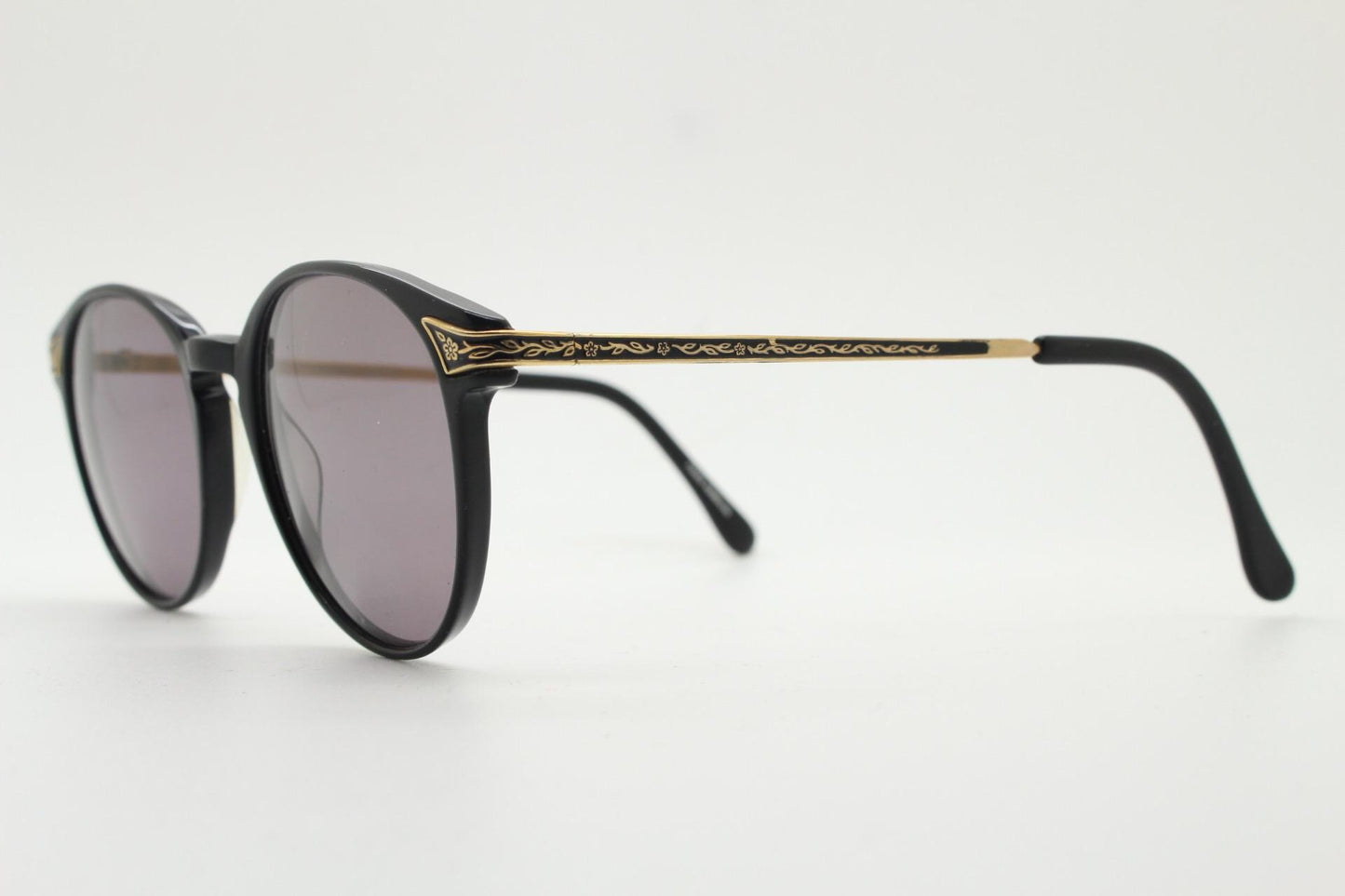 Laura Ashley 90s vintage round sunglasses. Refined 1940s design in black acetate with ornate embossed metal arm details. Unused NOS