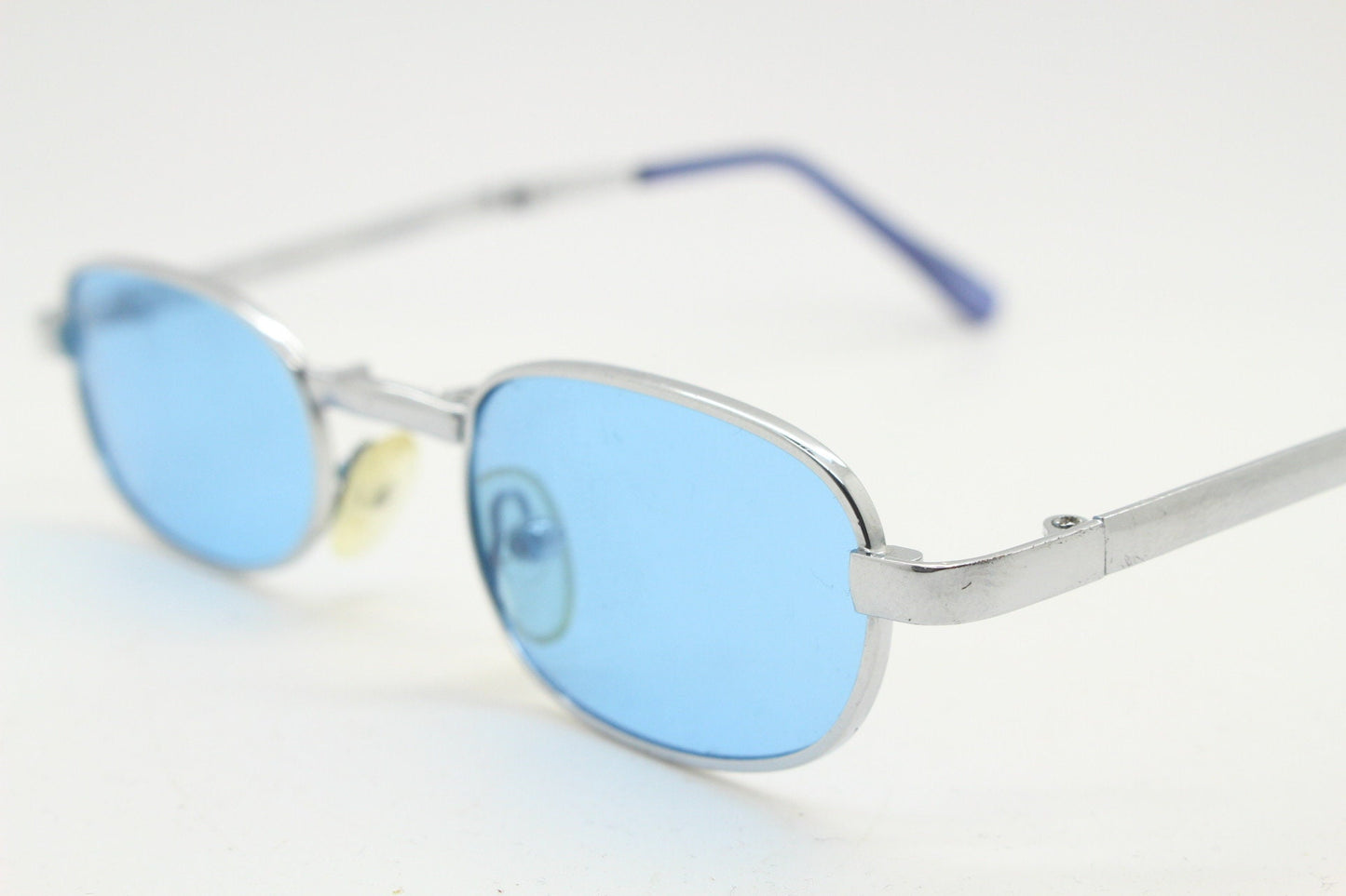 90s micro foldable oval sunglasses. Sky blue lenses in a small silver folding compact frame. Folder. Rave 2000s. Y2K. NOS
