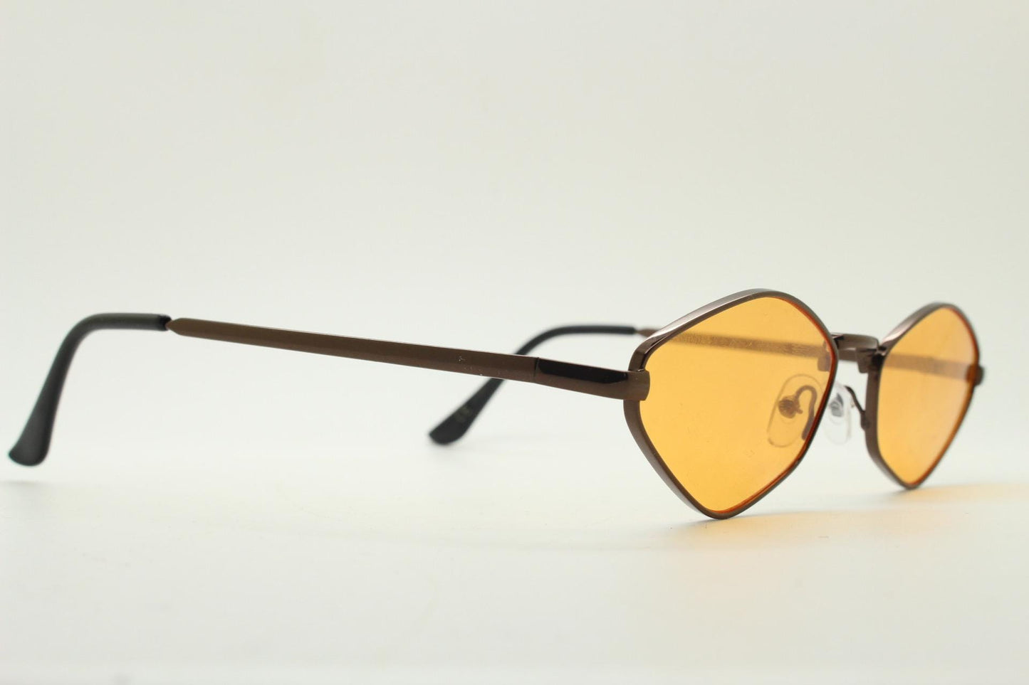 90s vintage pointed hexagon sunglasses. Minimal bronze brown psychedelic mod style frame with blazing orange lenses. Unused NOS