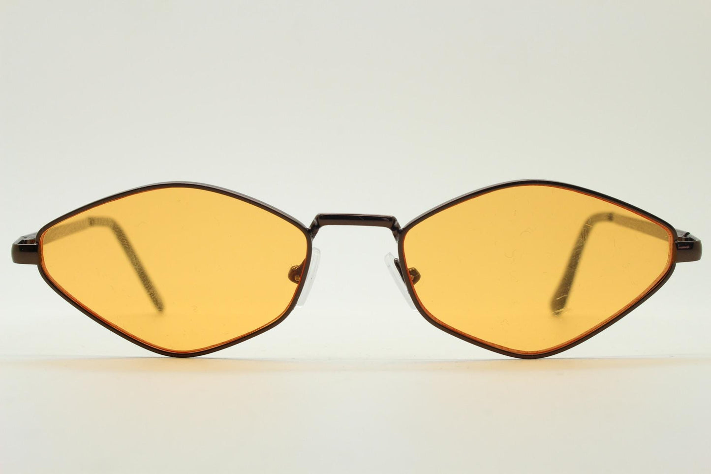 90s vintage pointed hexagon sunglasses. Minimal bronze brown psychedelic mod style frame with blazing orange lenses. Unused NOS