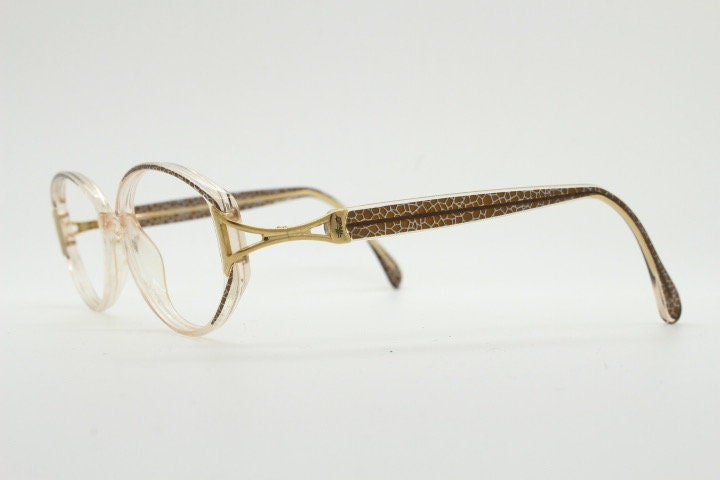 Silhouette 80s vintage oval eye glasses made in Austria. Transparent crystal optical frame with giraffe arm print. Prescription RX