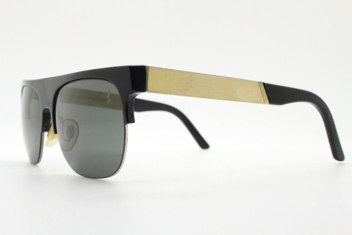 Retrosuperfuture vintage flat top half frame sunglasses hand made in Italy. Black gloss acetate front with tall golden arms