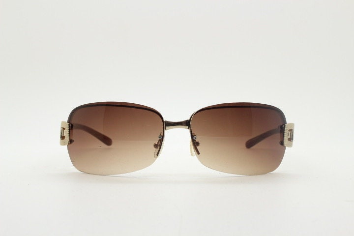 Y2K vintage rectangular brown sunglasses. Gold half frame 2000's wrap around with curved lenses, gold trim and temple crests. Unused NOS