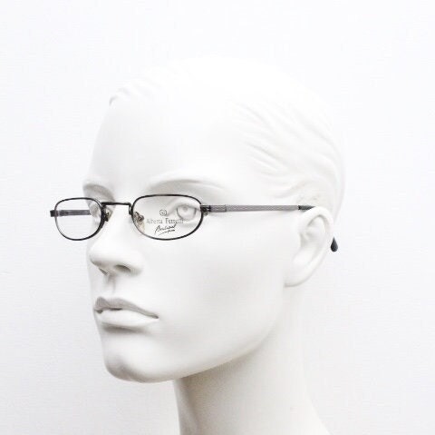 Alberta Ferretti 90s vintage oval eye glasses made in Italy. Small grey metal optical frame with ornate arm pattern. Prescription RX. NOS
