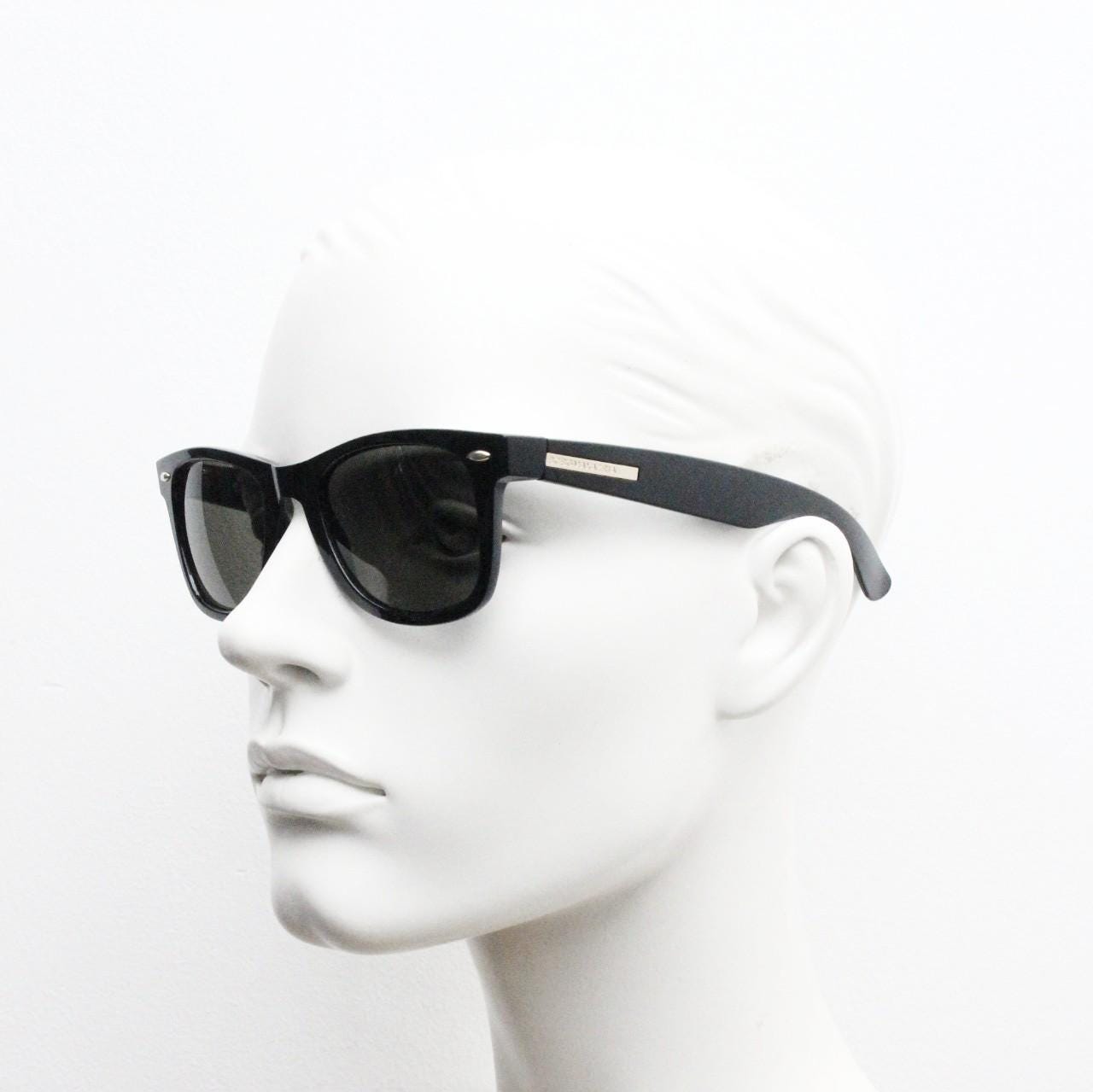 BCBG Max Azria vintage wayfarer design sunglasses. All time classic horn rim format in plain black gloss frame with green lenses.