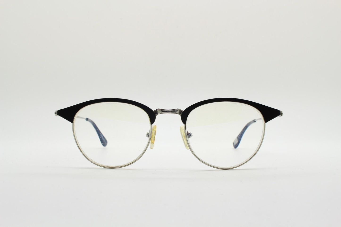 Lupo and Co round eye glasses with pointed corners. Flat metal silver optical frames with black browline. Prescription eyeglasses. RX