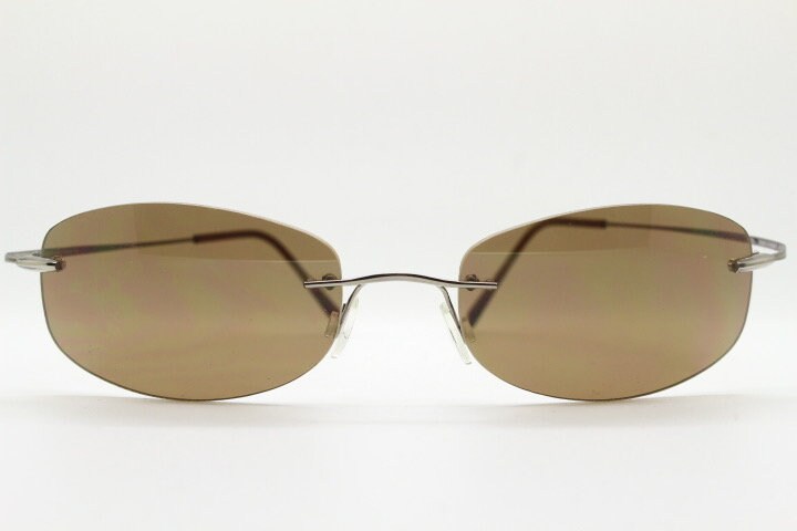 Faconnable 90s vintage sunglasses model 859 hand made in Italy. Minimal frameless design with flexible wire arms and brown chrome trim. NOS