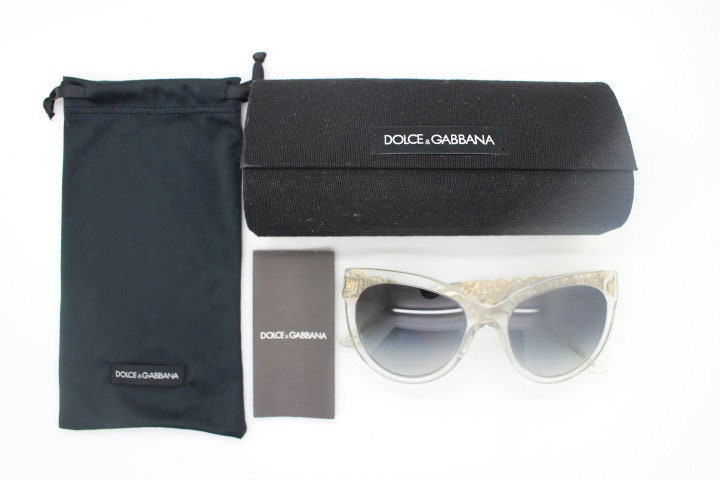 Dolce and Gabbana oversized cateye sunglasses model 4211. Womens transparent cat eye with cut-out florid metal arms and smoky lenses. NOS