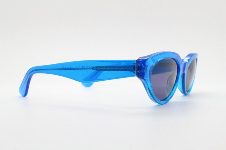 Retrosuperfuture thick cat eye sunglasses hand made in Italy. Intense blue acetate chunky frame with tasteful navy lenses. NOS