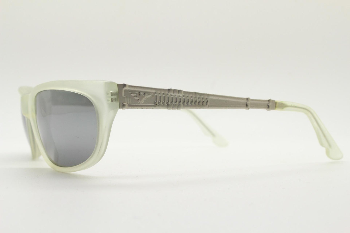 Dakota Smith vintage 90s futuristic sunglasses. Transparent frosted wrap around shield frame with mirror lenses and ornate arm patterns
