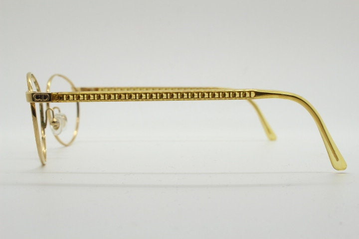 Christian Dior 90s vintage oval eye glasses made in Austria. Lustrous gold finish optical frame with CD chain link arms. Prescription RX NOS