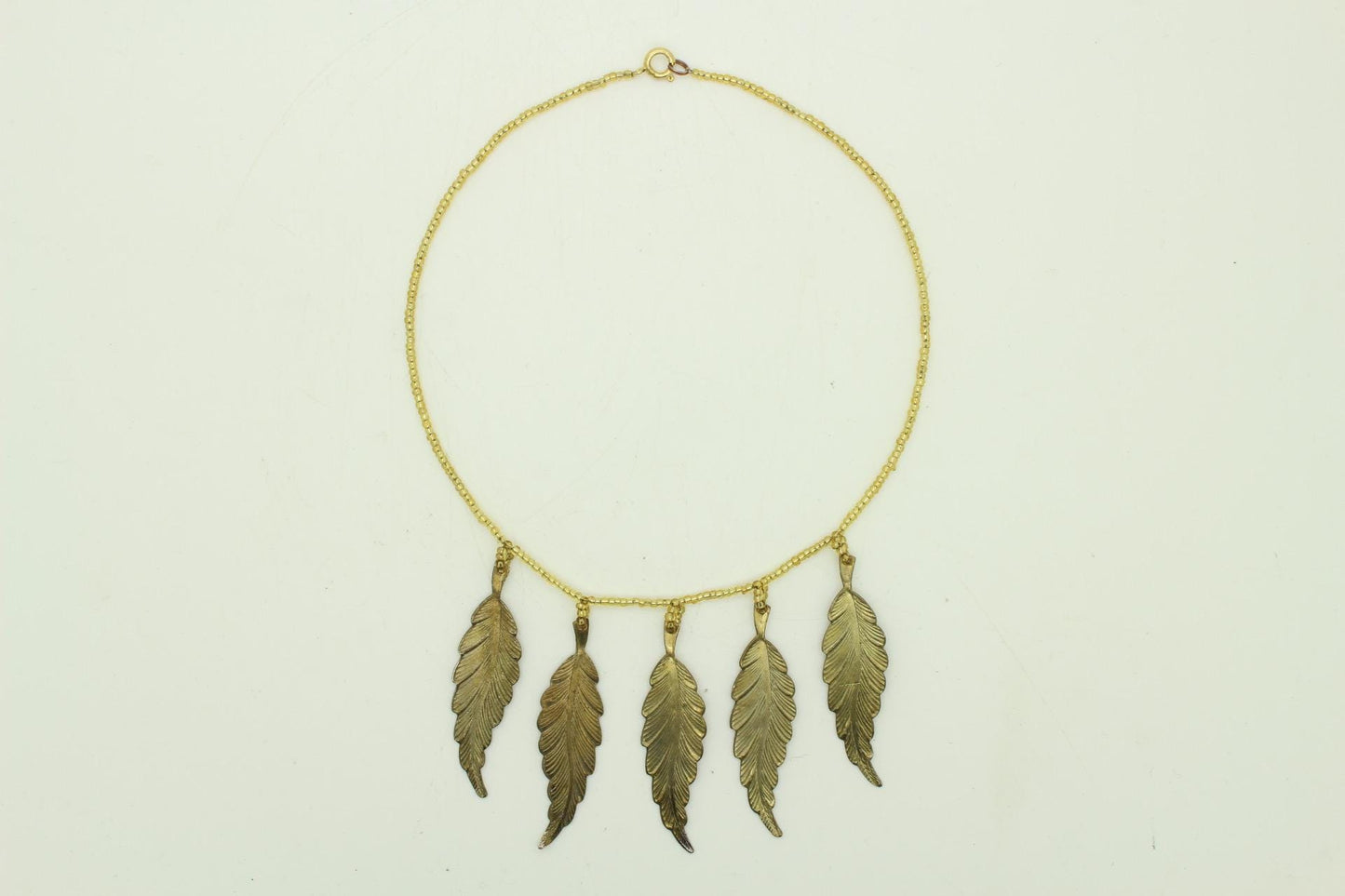 80s vintage gold beaded necklace with large dangling leaves . Charming statement piece. Country and western. Native american