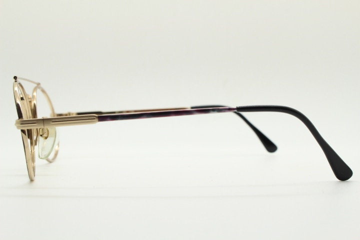 90s vintage oval eye glasses. Gold metal optical frame with vibrant enamel pattern and prominent double bridge. Prescription spectacles. NOS