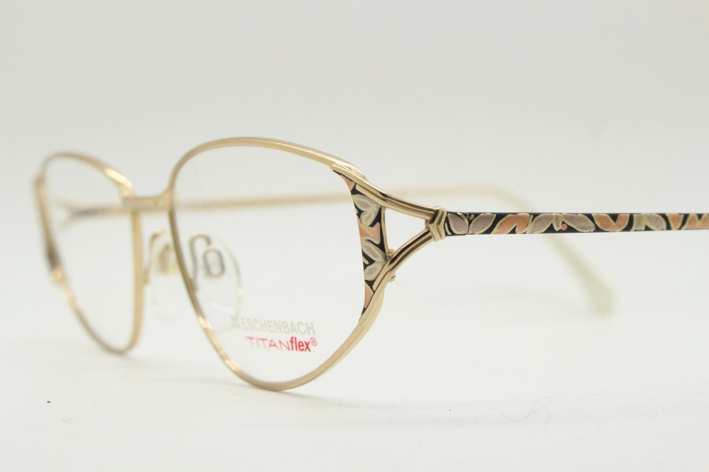 Eschenbach 90s vintage cropped cat eye glasses. Low profile gold metal optical frame with tasteful metallic arm pattern. Prescription. NOS