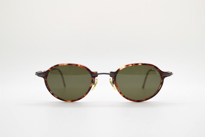 Sting 90s vintage oval sunglasses made in Italy. Refined 'industrial tech' fused with 1930s style in bronze metal and tortoise . Unused NOS