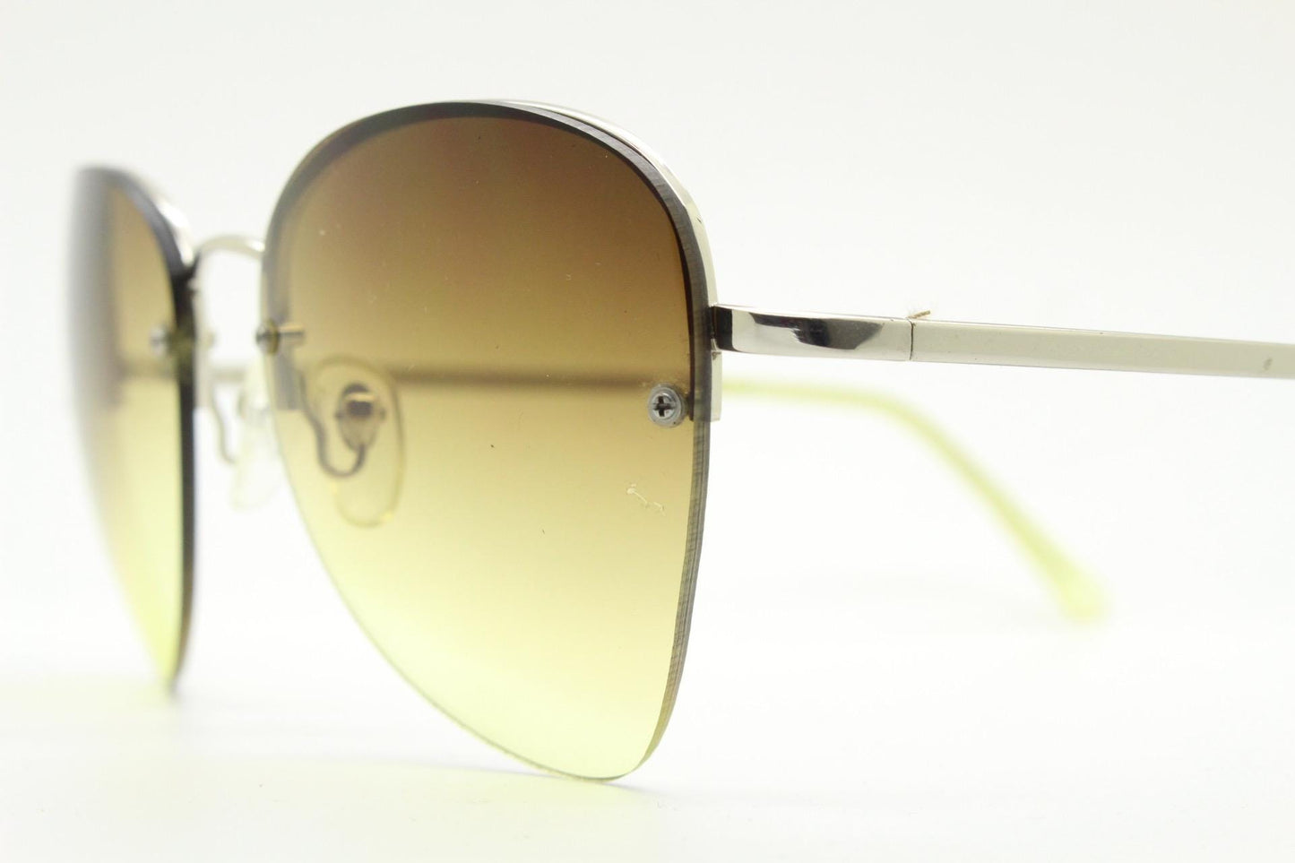 90s vintage modified teardrop aviator sunglasses. Minimal metal silver chrome half frame with compelling lenses. Teardrop aviators. NOS
