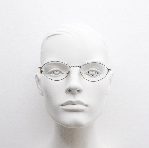 Viennaline 90s vintage oval eye glasses made in italy from titanium. Satin silver optical frame with grey enamel outline. Prescription RX