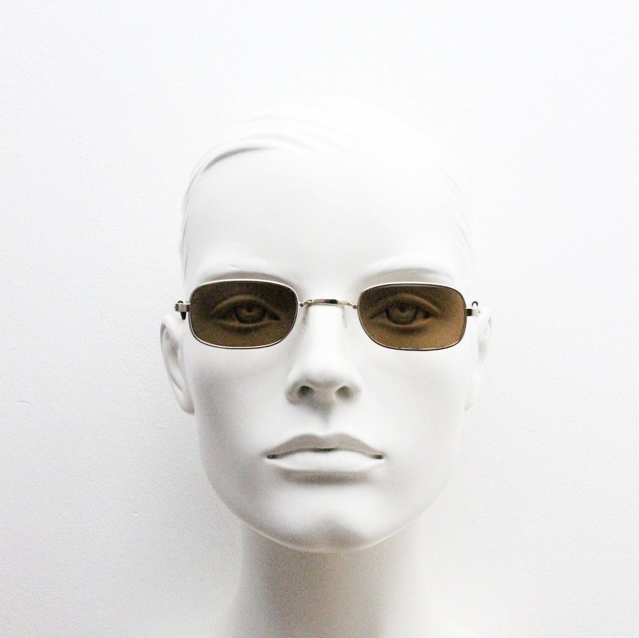 80s vintage rectangular low profile metal sunglasses. Minimal 60s mens mod design in gold chrome frame with brown lenses. NOS