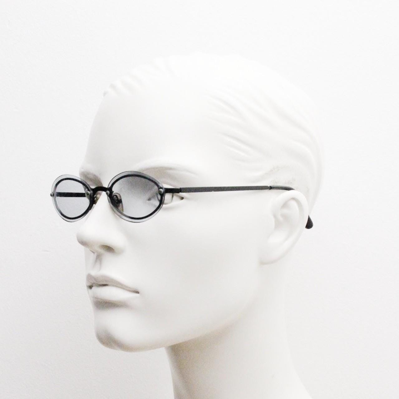 90s vintage small oval sunglasses. Minimal black metal frame with clever overlapping lens design in light tone grey. Micro. Steampunk. NOS