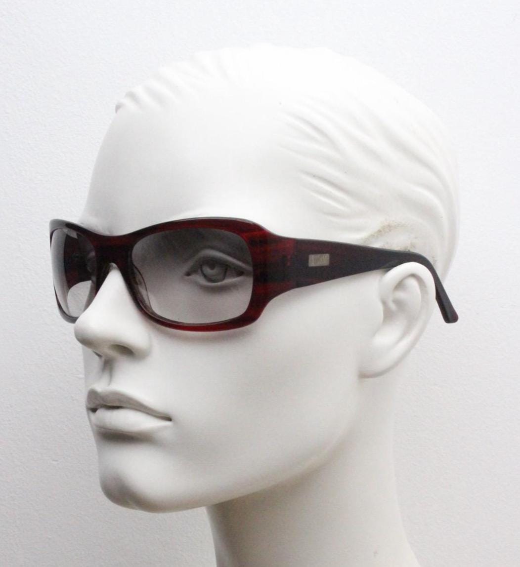 Y2k vintage wrap around large bug eye sunglasses. Curved red acetate shield frame with light tone lenses. 1960s bug eye design. 2000's NOS