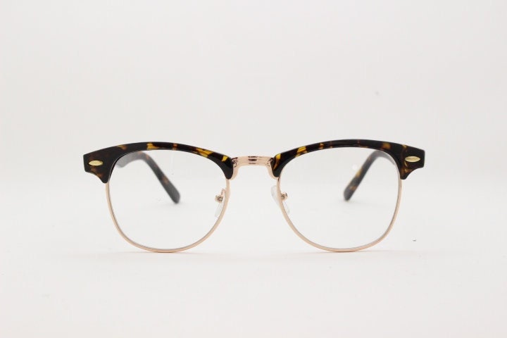 90s vintage half frame glasses. Tortoise browline eyeglasses in a gloss finish with gold underwire and clear lenses . Mens 50s, 60s design