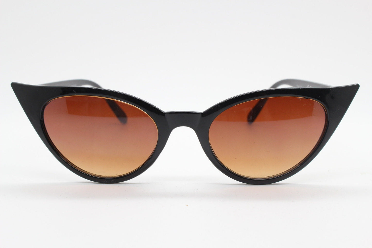 Y2K vintage pointed cat eye sunglasses. Womens black slender 50s style frame with Havana brown lenses. Rockabilly, bad girl pin up
