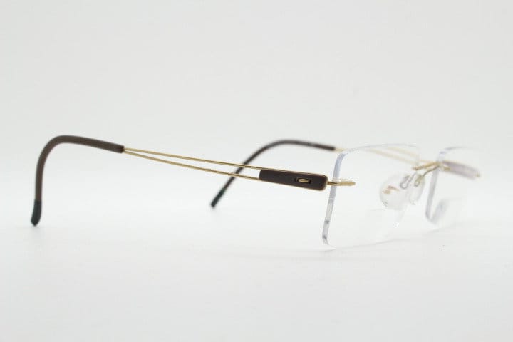 Silhouette rectangular frameless eye glasses model 7677 made in Austria. Minimal lightweight optical frame with golden trim. Prescription RX