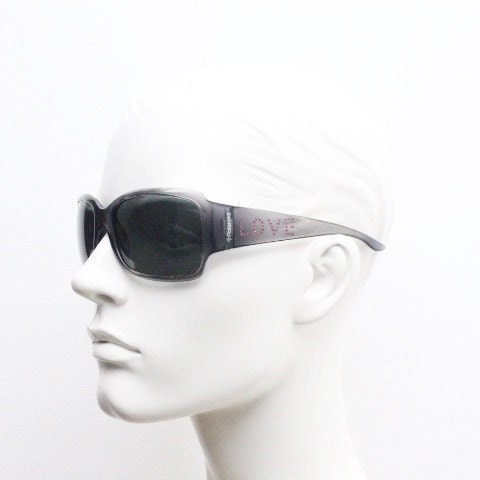Polaroid Y2K vintage shield sunglasses. Transparent grey wrap around with red diamante LOVE logo and polarising lens. 2000s. Rhinestone