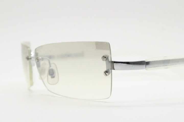Y2K vintage  frameless sunglasses. Minimal light tone curved mirrored lenses with white frosted arms. 2000's. 90s. 00s. NOS