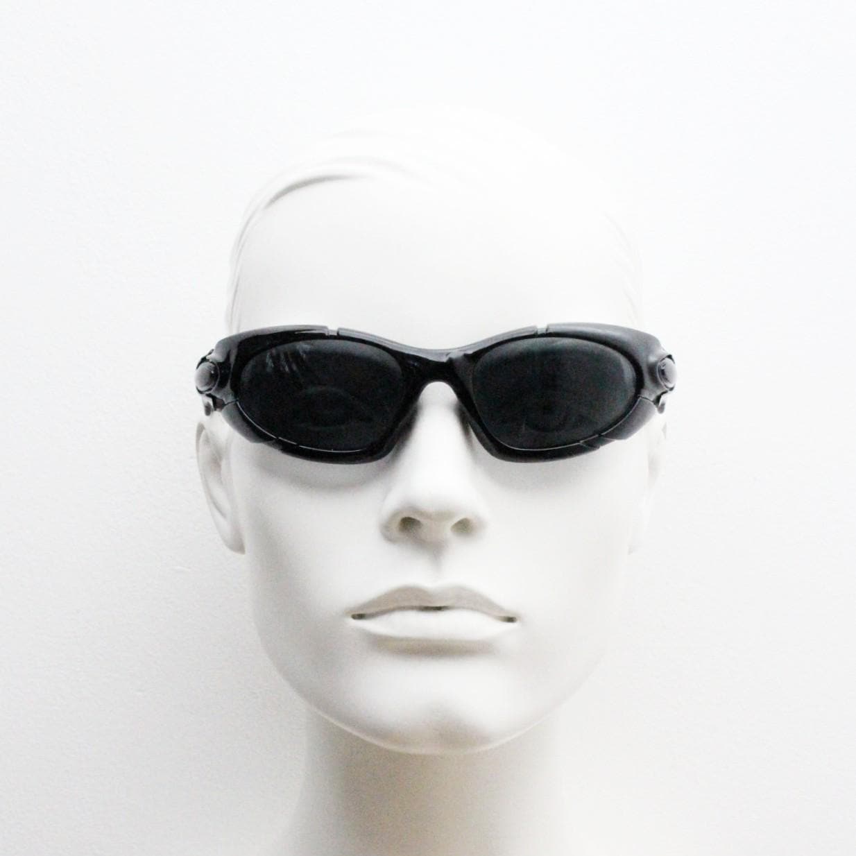 90s vintage sports shield sunglasses. All black gloss aerodynamic wraparound with many stylised features. 2000's. Hells angel uber fashion