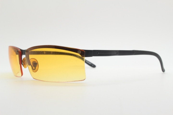 Y2K vintage half frame visor sunglasses. 2000's black brow line with light tone blazing orange rectangular curved lenses. 00's