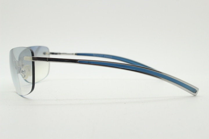 Y2K vintage wraparound sunglasses. Low profile frameless design in black matt finish with light tone graduated mirror lenses. 2000's. NOS