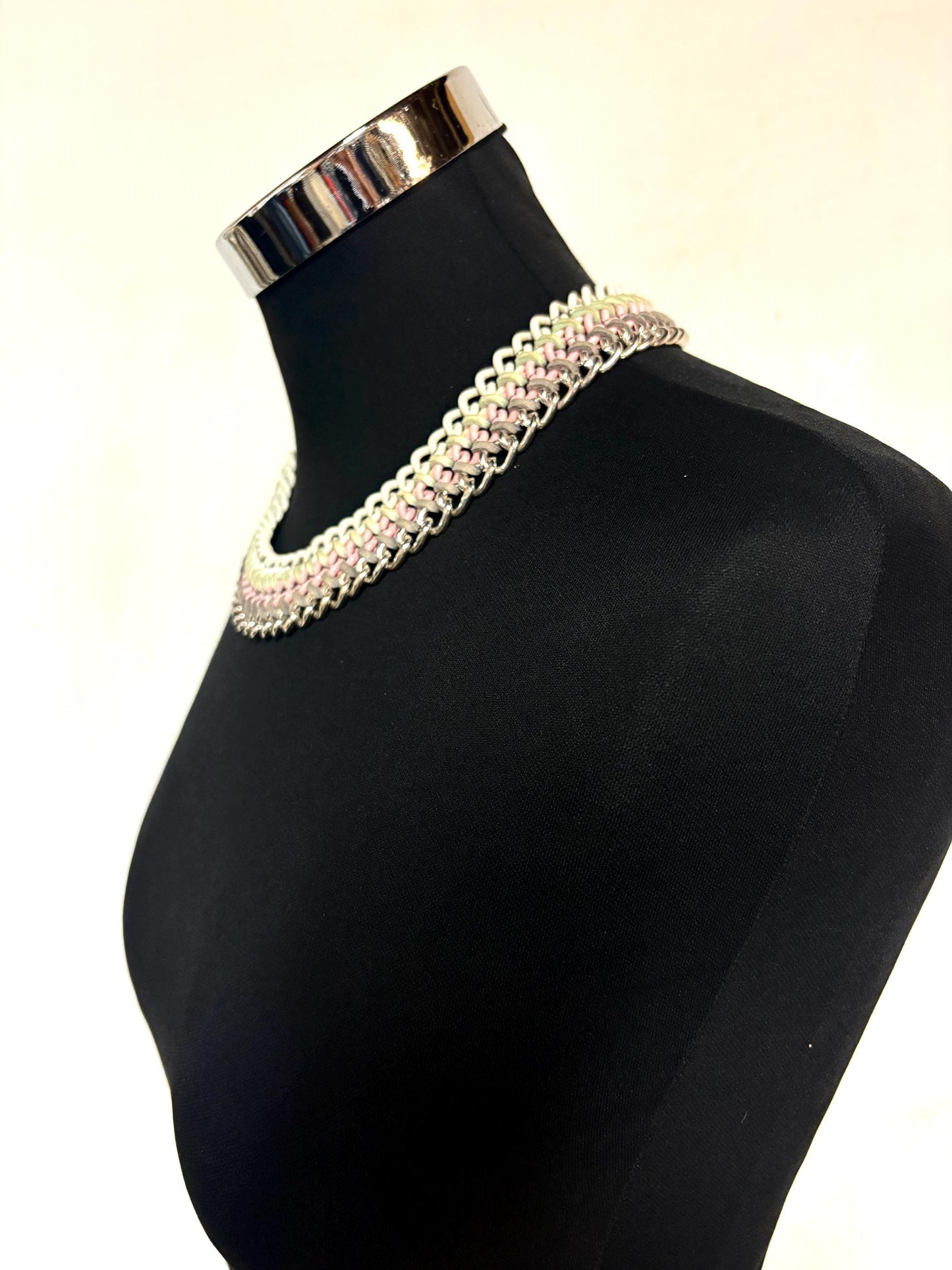 90s vintage 3 tier chain necklace. Solid metal construction in silver, pink, and white tones with grey rubber bonds. Adjustable back