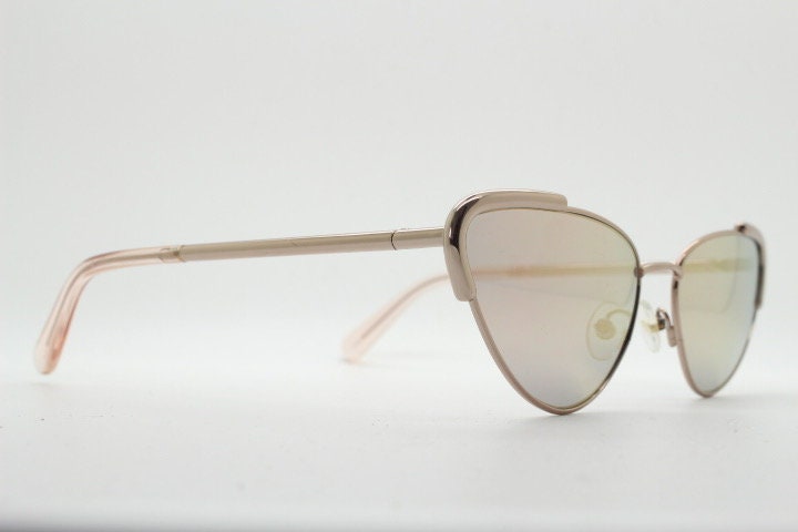 Rebecca Minkoff futuristic golden oval cat eye sunglasses. Women's rose gold metal cateye frame with sunburst mirror lenses. NOS