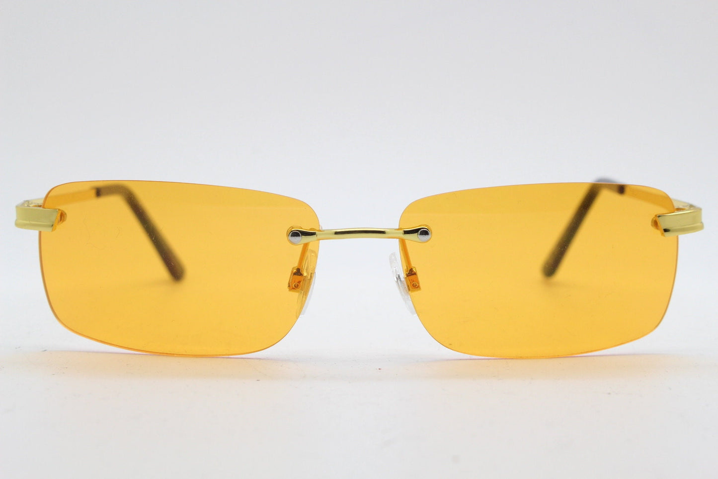 Y2K vintage frameless orange sunglasses. Rectangular lenses with gold bridge and arms. 2000s club kids. 00's. 90s Rave