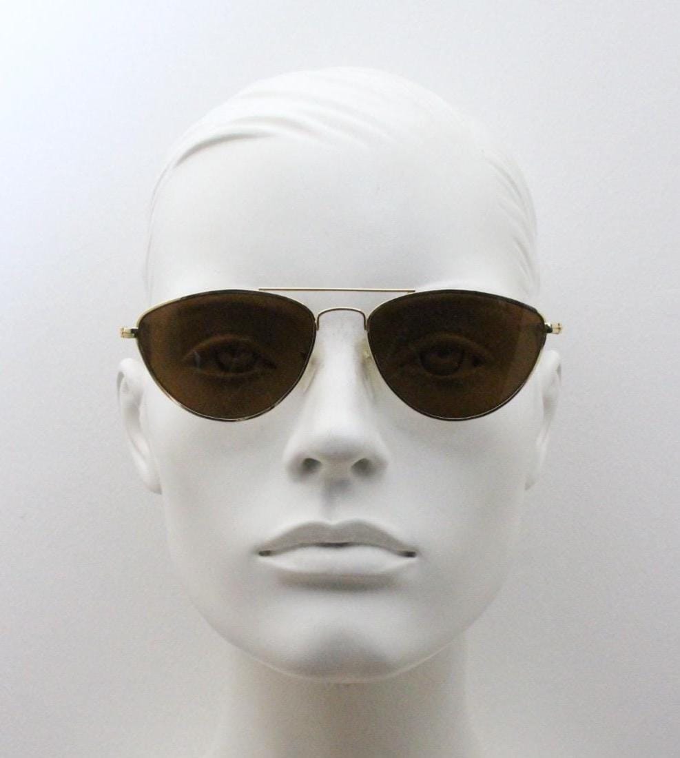 90s vintage minimal triangular sunglasses. Slim gold frame with plain brown lenses. Small modified aviator design. NOS