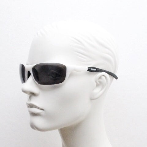 Y2K vintage visor sunglasses. Black and white superhero style sport shield with curved black lenses. Aerodynamic wrap around. NOS rave