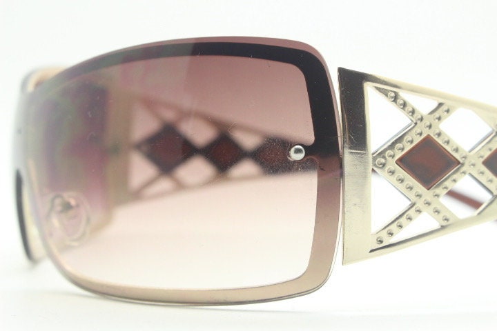 Y2K vintage visor sunglasses. 2000's brown wraparound mono lens mini mask shield design with stupendous lattice arms. Bug eye. Unworn NOS