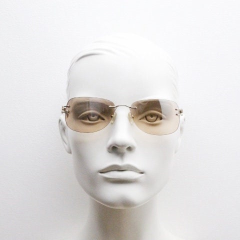 Y2K vintage rimless rectangular sunglasses. Frameless 2000's brown lens with slight mirror glaze gold trim and butterfly hinges. 00's NOS