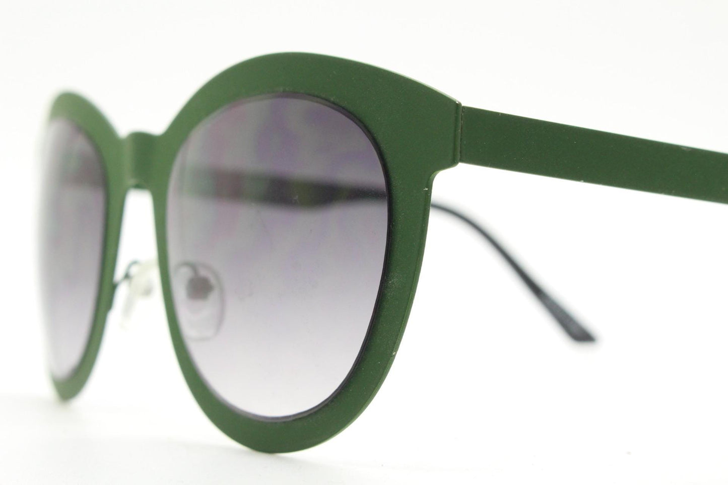 Round vintage cat eye sunglasses. Green flat metal frame in a slightly rubber finish that encases the lenses. Womens 2000s modified cateye