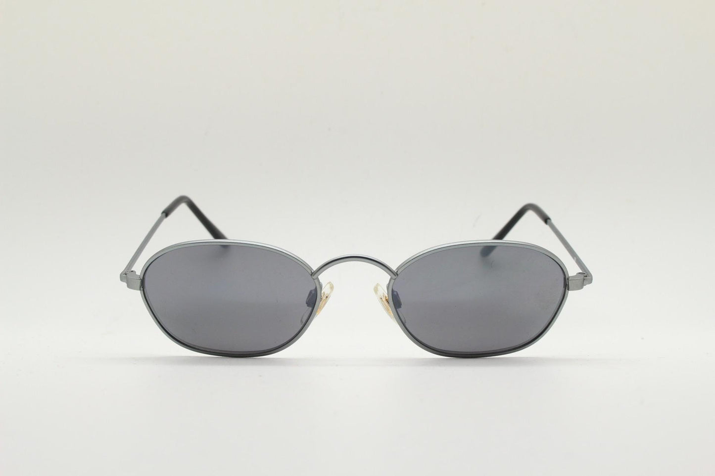 90s vintage small angular oval bug eye sunglasses. Minimal brushed satin finish frame with silver mirror lenses. Y2K. 2000s. Unworn NOS