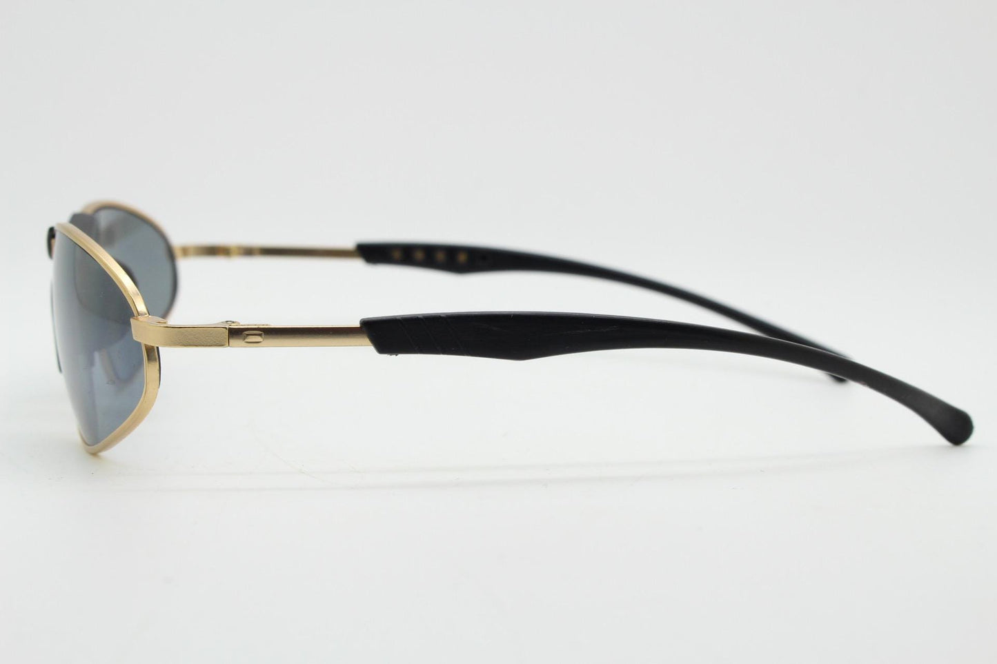 90s vintage oval small bug eye sunglasses. Curved gold satin finish metal frame with black matt trim and adjustable arm length. Unused NOS