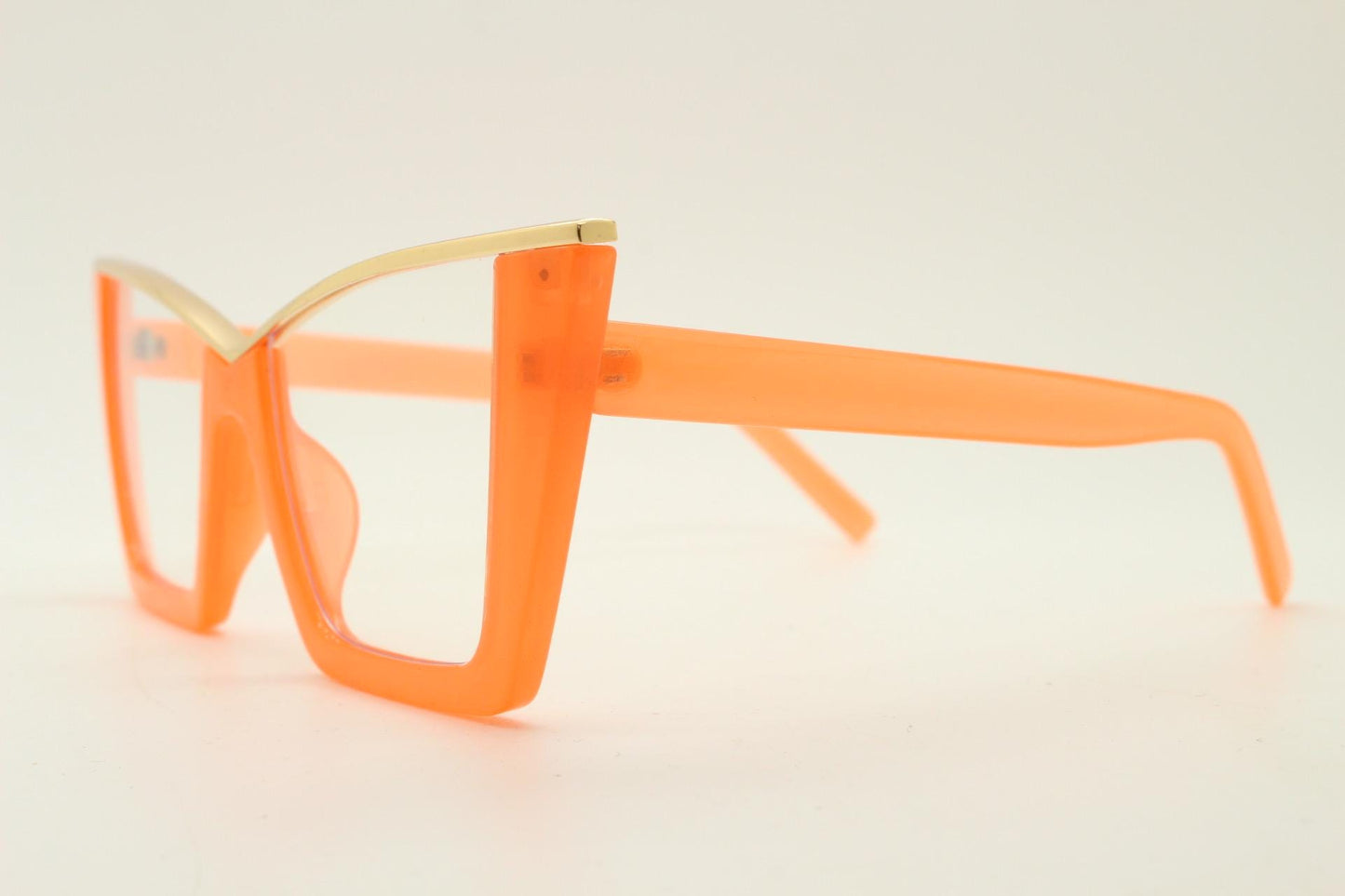 Dynamic pointed cat eye glasses. Transparent thick orange optical frame with gold metal 'owl' brow. and clear lenses. Vintage. Prescription
